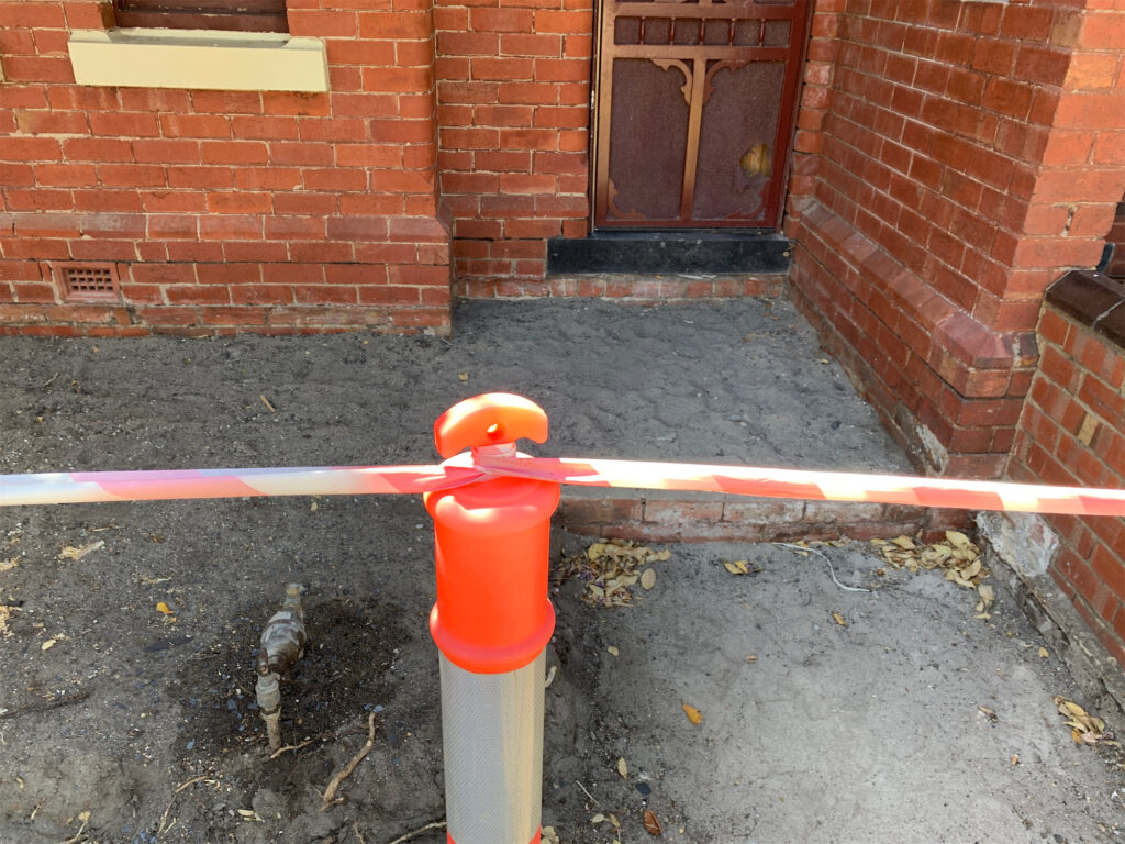 Construction barrier at brick house