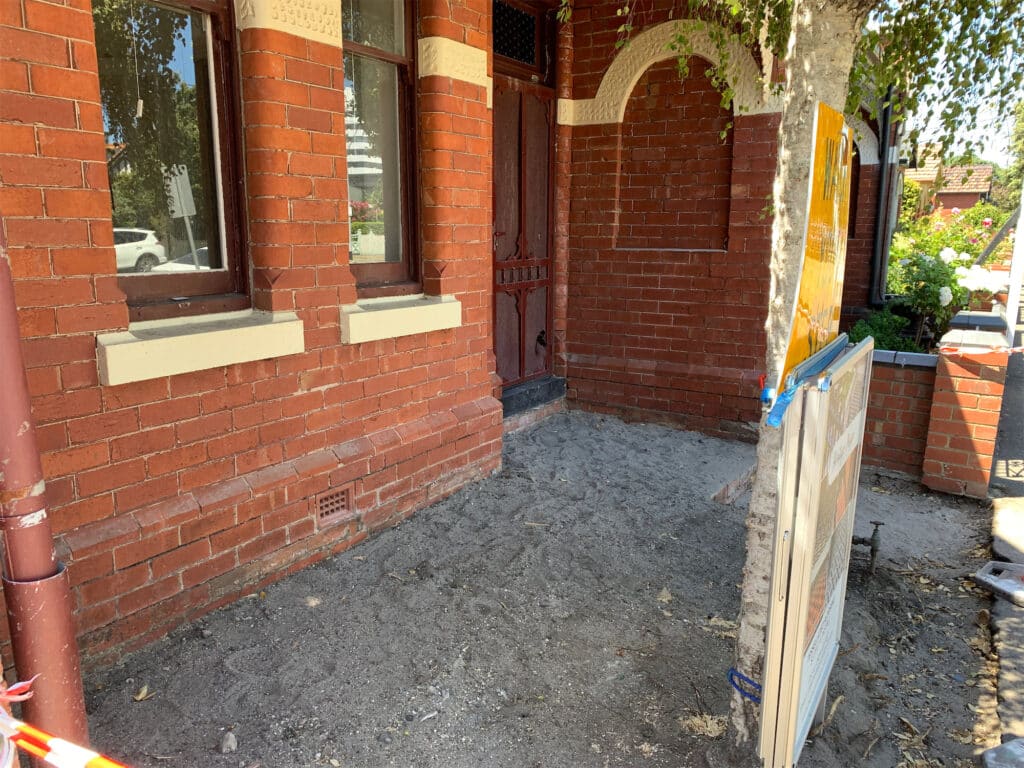 Brick building exterior with dirt path
